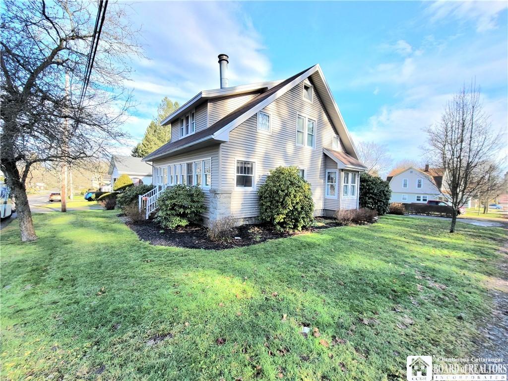 view of property exterior with a lawn