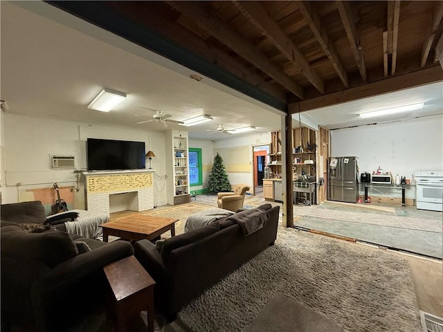 basement with stainless steel fridge, ceiling fan, a wall mounted air conditioner, and a brick fireplace