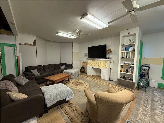 living room with ceiling fan and built in features