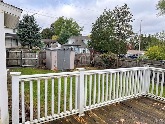 deck featuring a storage shed and a lawn