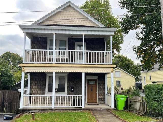 view of front of property featuring covered porch and a balcony