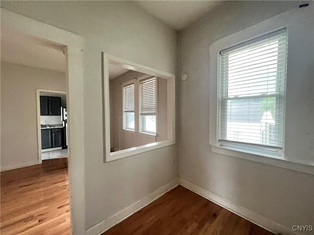 corridor with hardwood / wood-style floors