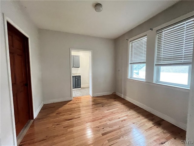 spare room with light hardwood / wood-style flooring