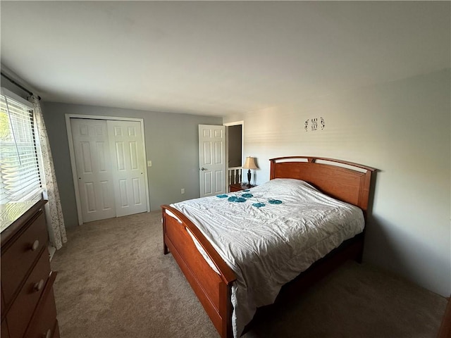 bedroom featuring light colored carpet and a closet