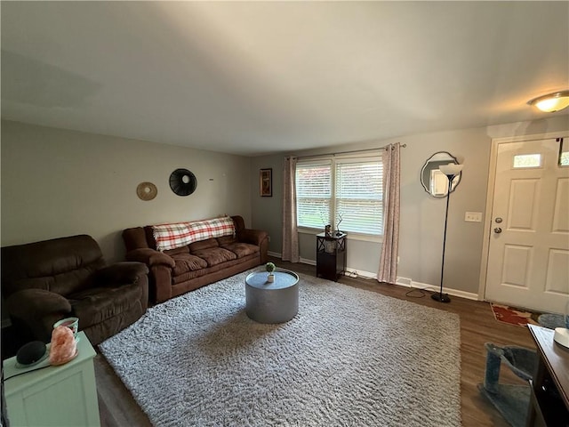 living room featuring dark wood finished floors and baseboards