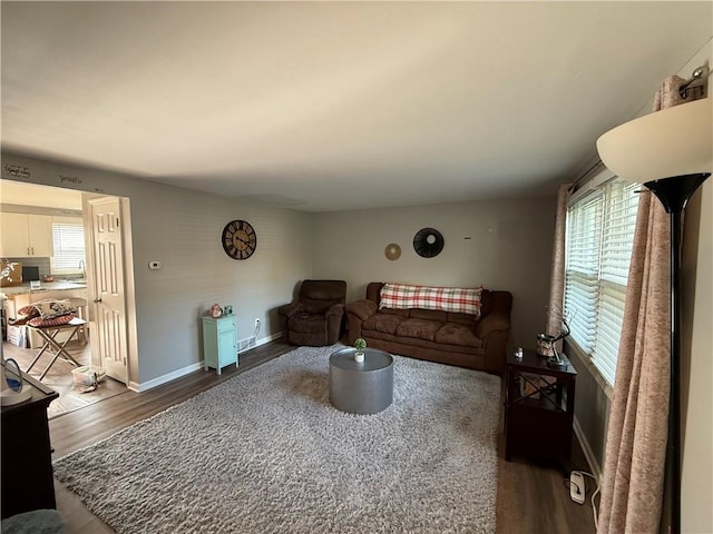living room with wood finished floors and baseboards