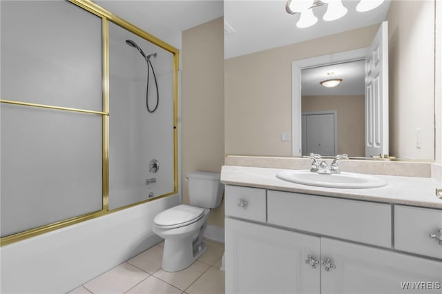 full bathroom featuring tile patterned floors, toilet, combined bath / shower with glass door, and vanity