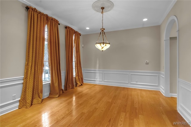 unfurnished room featuring light wood-type flooring and ornamental molding