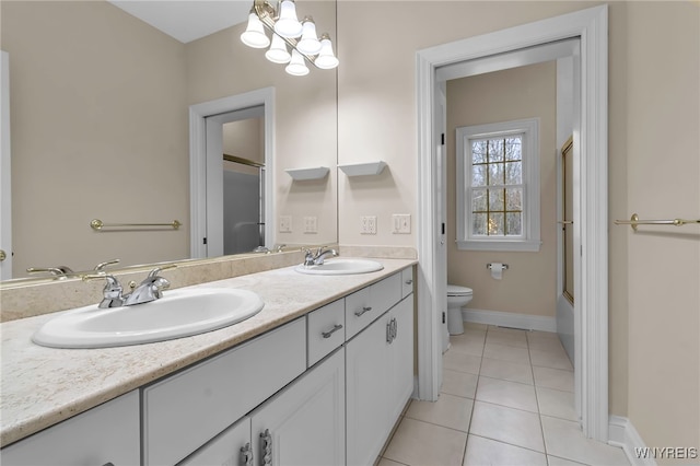 full bathroom with tile patterned floors, bath / shower combo with glass door, vanity, a notable chandelier, and toilet