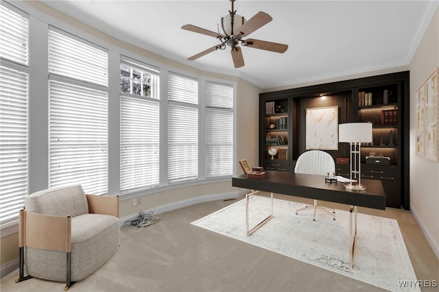 office space featuring ceiling fan, light colored carpet, and ornamental molding