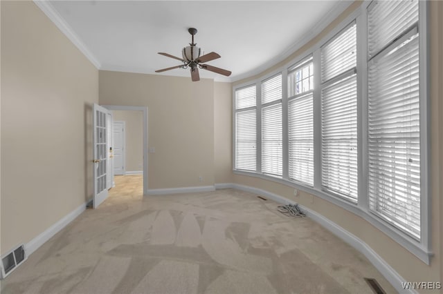 carpeted spare room with crown molding and ceiling fan