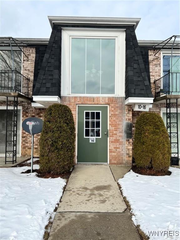 view of snow covered property entrance