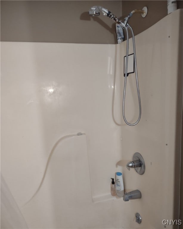 interior details featuring shower / bathtub combination