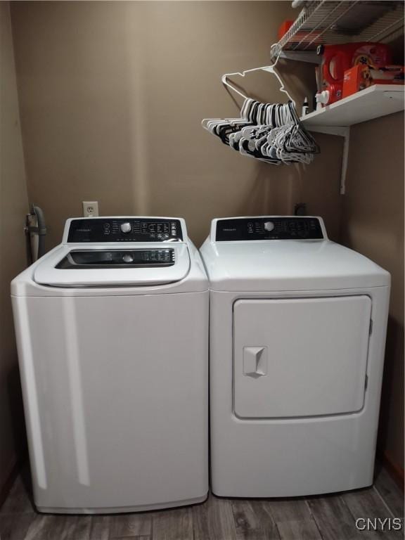 laundry area featuring washing machine and dryer and dark hardwood / wood-style flooring