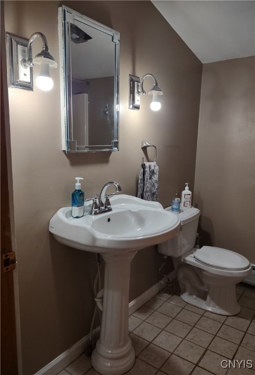 bathroom with toilet and tile patterned flooring