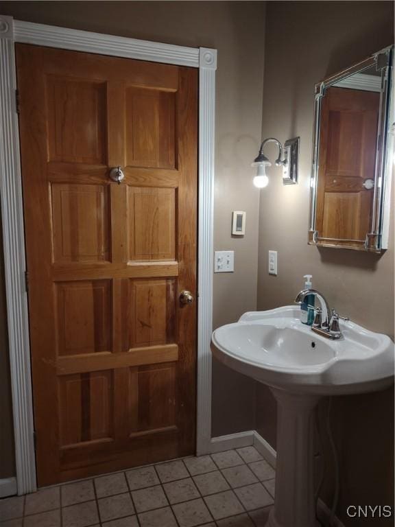 bathroom with sink and tile patterned flooring