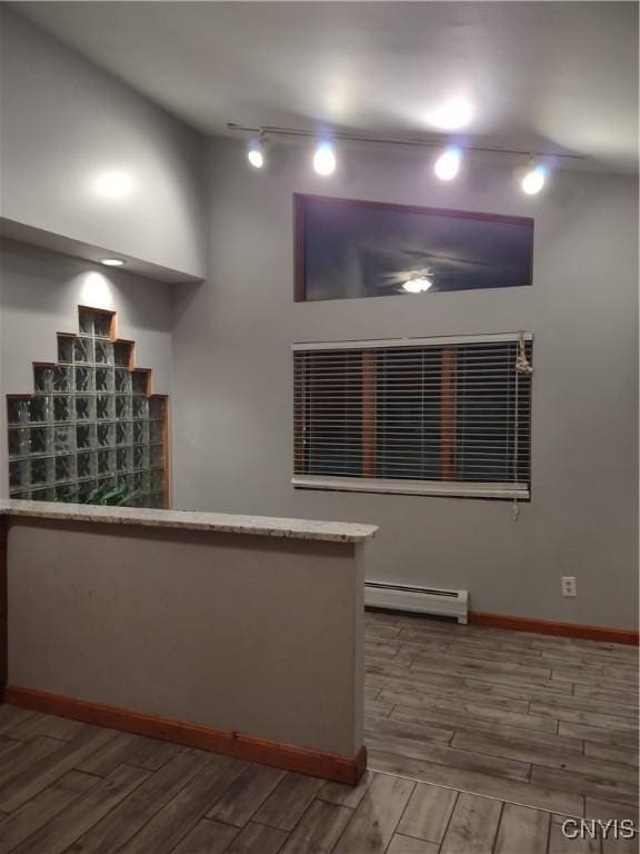 kitchen with baseboard heating and rail lighting