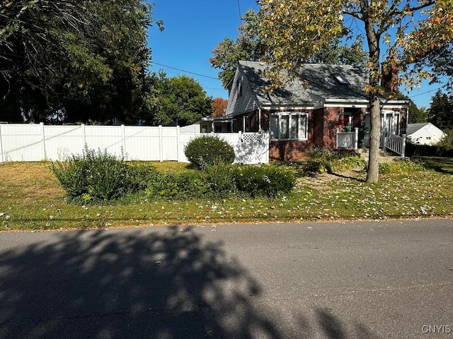 view of side of home with a yard