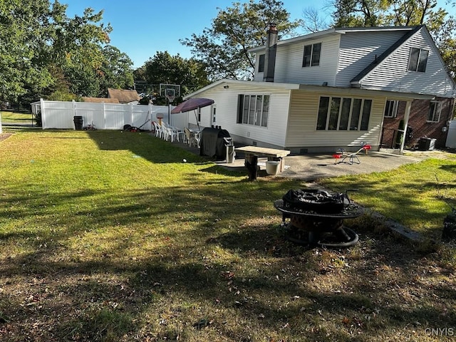 rear view of property with a patio area and a yard