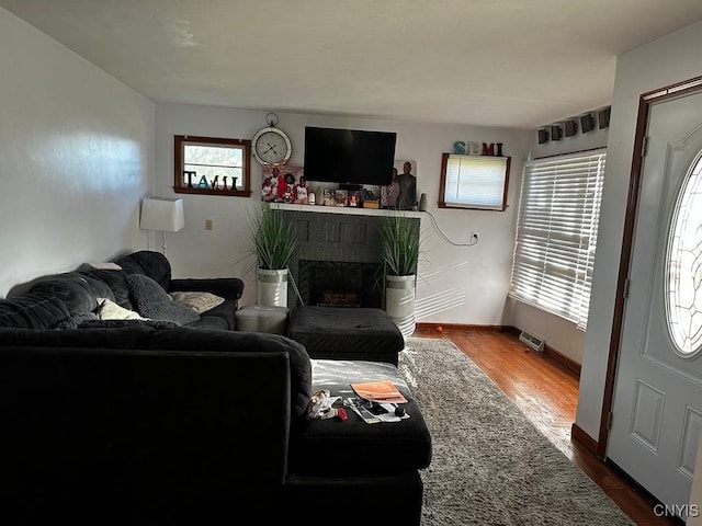 living room with a fireplace and hardwood / wood-style floors