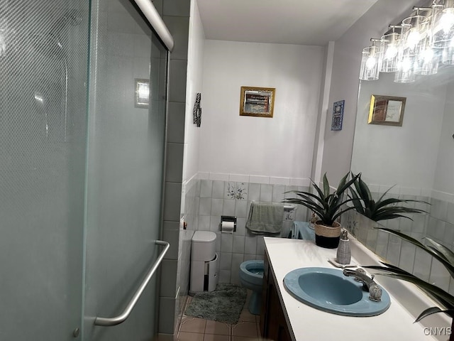 bathroom featuring tile patterned flooring, an enclosed shower, toilet, vanity, and tile walls