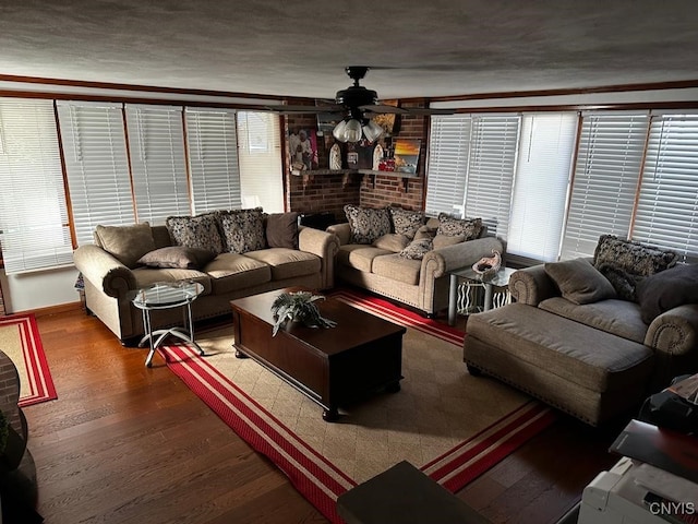 living room with hardwood / wood-style flooring, ceiling fan, and ornamental molding