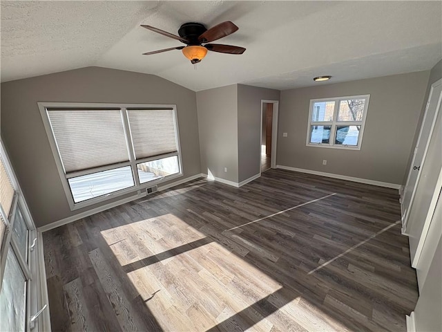 unfurnished bedroom featuring a textured ceiling, lofted ceiling, ceiling fan, a closet, and dark hardwood / wood-style flooring