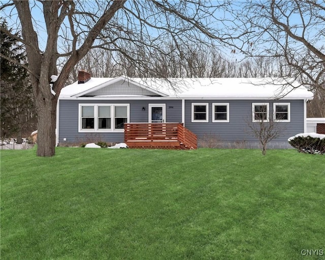 view of front of home with a deck and a front yard