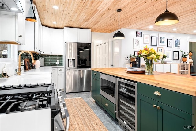 kitchen featuring stainless steel appliances, white cabinets, pendant lighting, wood ceiling, and wine cooler