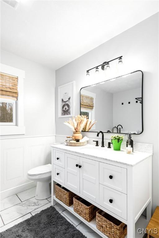 bathroom featuring vanity and toilet