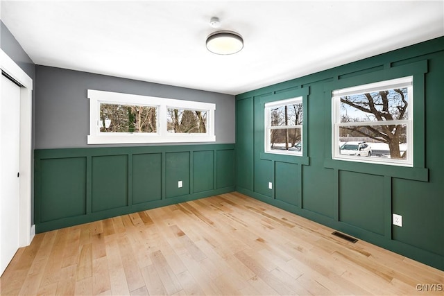 interior space featuring light wood-type flooring and plenty of natural light