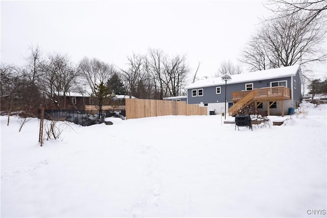 yard layered in snow featuring a wooden deck