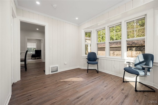 sitting room with wood-type flooring and ornamental molding