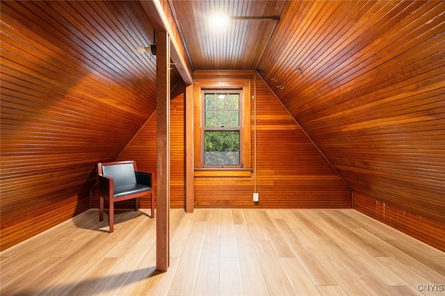 additional living space with wooden walls, hardwood / wood-style floors, and wood ceiling