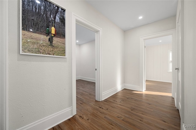 hallway with dark hardwood / wood-style floors