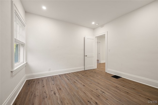 spare room with dark hardwood / wood-style flooring