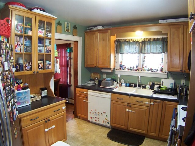 kitchen with sink, white appliances, and a baseboard heating unit