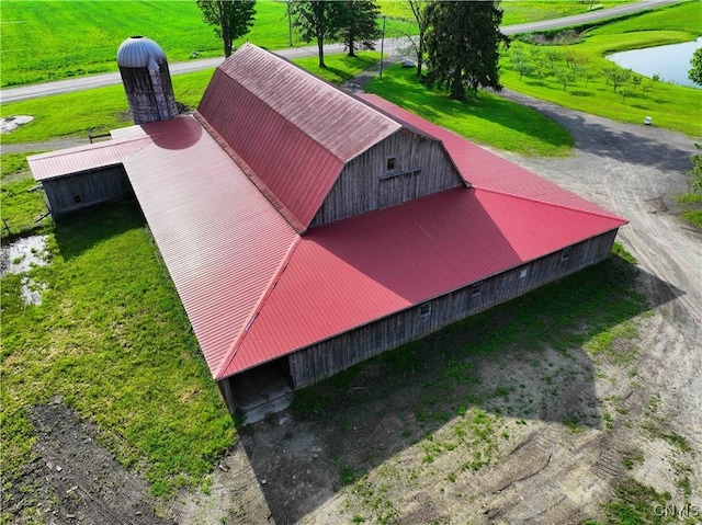 entry to storm shelter featuring a water view and an outdoor structure