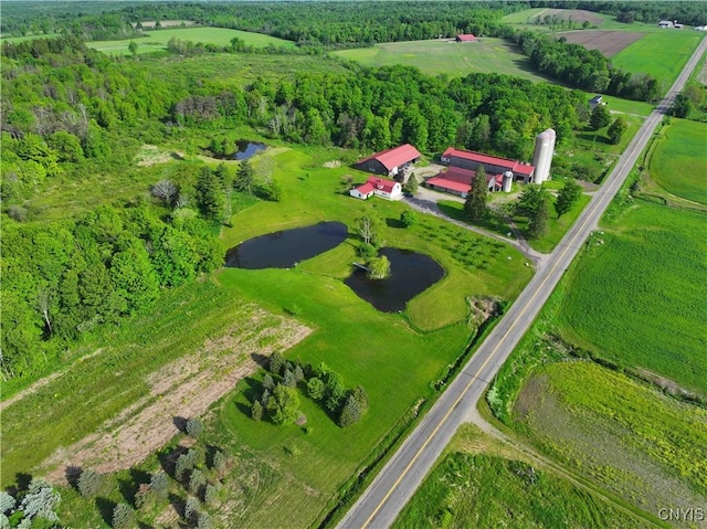 birds eye view of property featuring a water view and a rural view