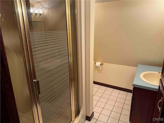 bathroom featuring tile patterned flooring, vanity, and an enclosed shower