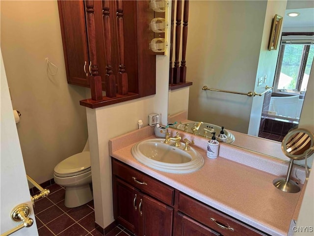 bathroom featuring tile patterned flooring, vanity, and toilet