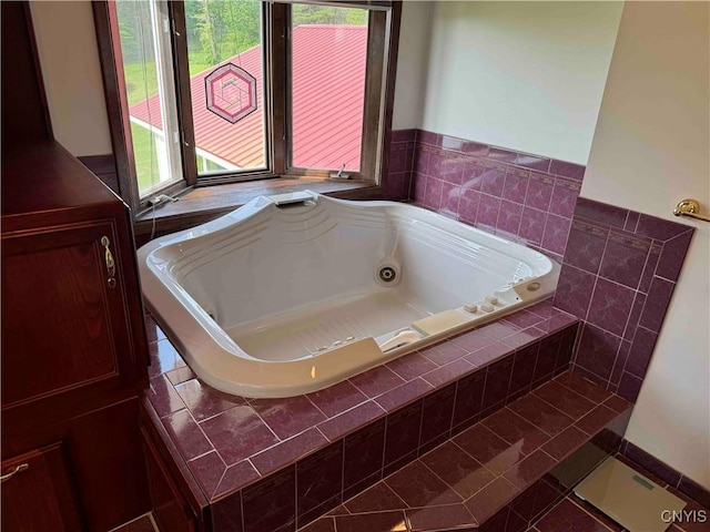 bathroom with tile patterned flooring and tiled bath