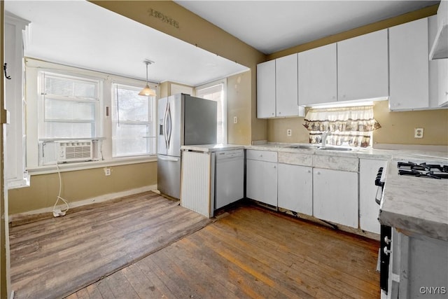 kitchen with white cabinetry, sink, pendant lighting, and stainless steel refrigerator with ice dispenser