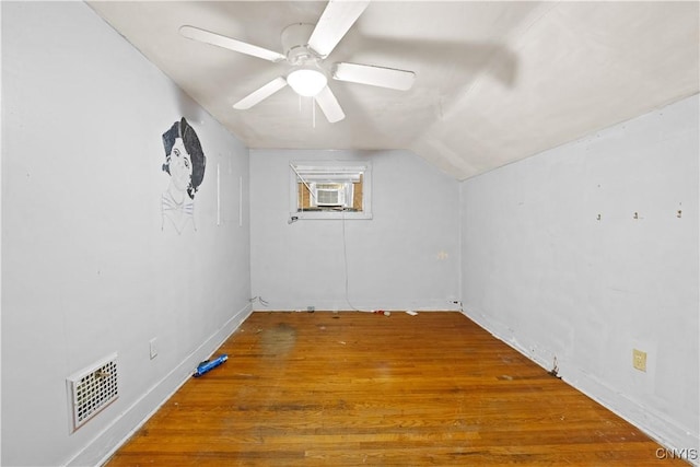 additional living space with hardwood / wood-style flooring, vaulted ceiling, ceiling fan, and cooling unit