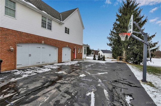 view of snowy exterior with a garage