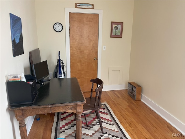 home office with hardwood / wood-style floors