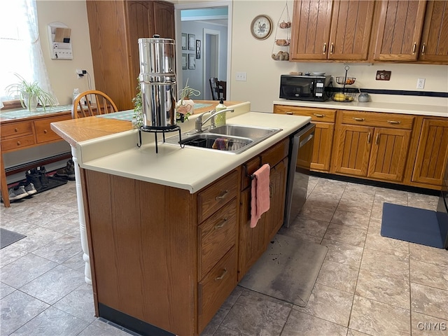 kitchen with stainless steel dishwasher, a kitchen island with sink, and sink