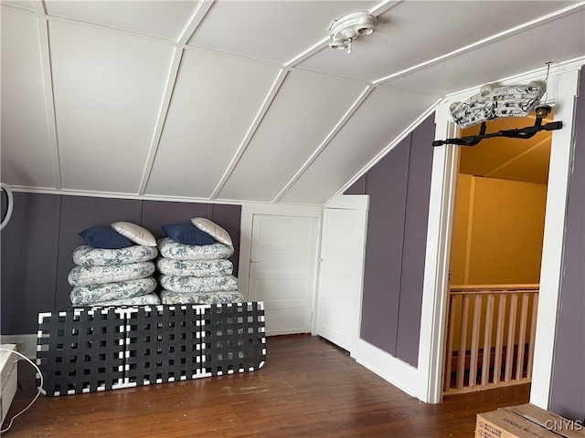 additional living space featuring wood-type flooring and vaulted ceiling