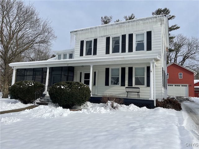 view of front of house with a garage and an outbuilding