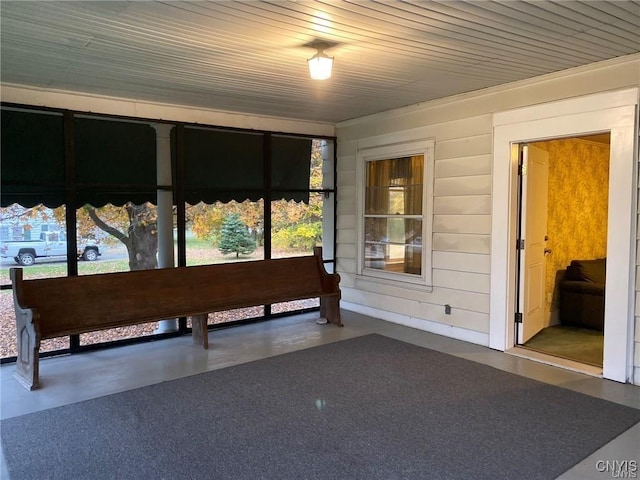 unfurnished sunroom featuring wood ceiling